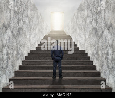 Businessman standing for walking up stairs to the door over the cloud sun over the cityscape background,Success business and Ambitions concept Stock Photo