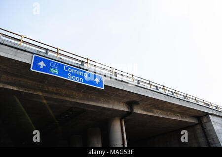 Coming Soon Blue Road Sign Against Clear Sky Stock Photo