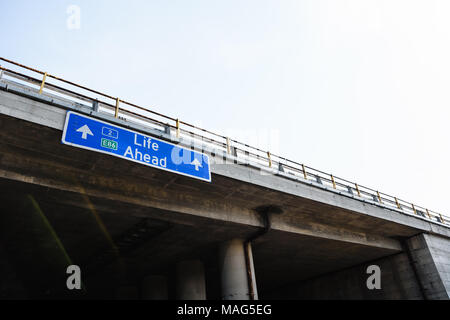 Life Ahead Blue Road Sign Against Clear Sky Stock Photo