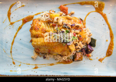 Gourmet plated dish featuring local and sustainably-sourced blue catfish, pan-seared and glazed with a sweet curry sauce. Served with HoppinÕ John and Stock Photo