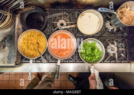 Preparing various dishes in a commercial kitchen in Baltimore, MD Stock Photo