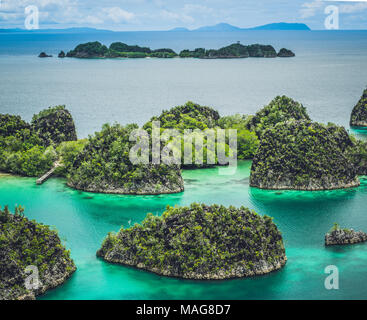 Painemo, Group of small island in shallow blue lagoon water, Raja Ampat, West Papua, Indonesia Stock Photo