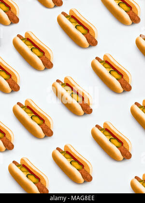 Hot dog Pattern with hot dogs with mustard and pickled cucumbers on white background Stock Photo