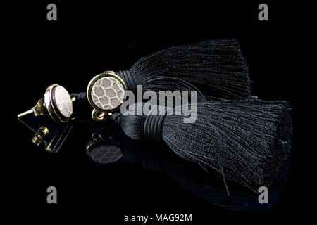 Female elegant ornaments on a black background. Copy space. Stock Photo