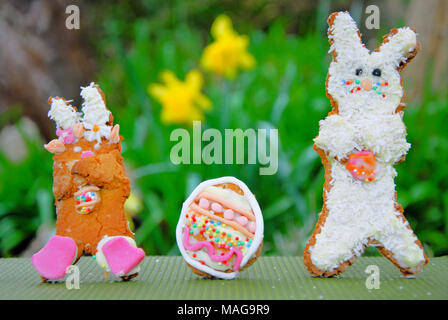 Portland, UK. 1st April 2018 - Student, Sophie (22), has fun baking Easter treats - 'Snowy and 'Rapper' bunny with their own egg, in Sophie's Portland garden Stock Photo