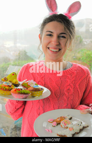 Portland, UK. 1st April 2018 - Student, Sophie (22), has fun baking tasty Easter treats on cold, rainy Sunday on the Isle of Portland in Dorset Stock Photo