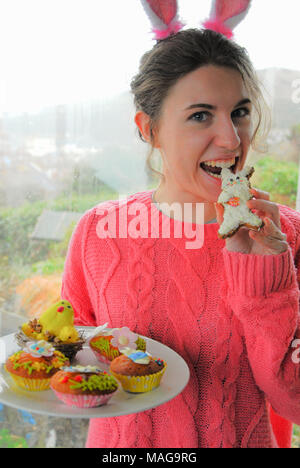 Portland, UK. 1st April 2018 - Student, Sophie (22), has fun baking tasty Easter treats on cold, rainy Sunday on the Isle of Portland in Dorset Stock Photo