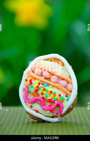 Portland, UK. 1st April 2018 - Student, Sophie (22), has fun baking Easter treats - 'Snowy and 'Rapper' bunny with their own egg, in Sophie's Portland garden Stock Photo