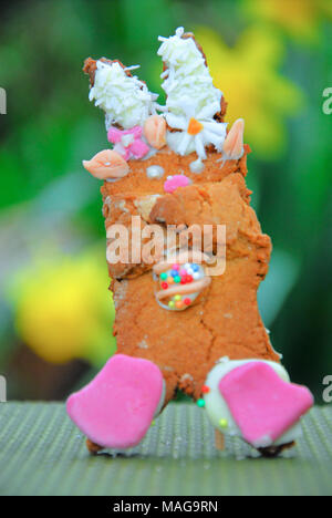 Portland, UK. 1st April 2018 - Student, Sophie (22), has fun baking Easter treats - 'Snowy and 'Rapper' bunny with their own egg, in Sophie's Portland garden Stock Photo