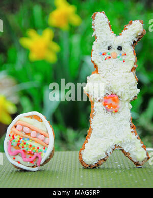 Portland, UK. 1st April 2018 - Student, Sophie (22), has fun baking Easter treats - 'Snowy and 'Rapper' bunny with their own egg, in Sophie's Portland garden Stock Photo