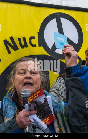 Aldermaston, UK. 1st Apr, 2018. Dr Rebecca Johnson,  co-Chair of ICAN, long-time feminist peace campaigner and 2017 Nobel Laureate, holds up a copy of the UN treaty banning nuclear weapons. which was finalised last year and signed by 122 nations as she speaks at the CND celebration of the 60th anniversary of the first Aldermaston march which mobilised thousands against the Bomb and shaped radical protest for generations. Credit: Peter Marshall/Alamy Live News Stock Photo