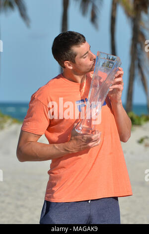 Miami, FL, USA. 1st Apr, 2018. KEY BISCAYNE, FL - APRIL 01: John Isner (USA) heads to the Crandon State Park Beach for pictures with the Championship Trophy after defeating Alexander Zverev (GER) 67(4) 64 64 at the 2018 Miami Open held at the Tennis Center at Crandon Park on April 1, 2018. Credit: Andrew Patron/Zuma Wire Credit: Andrew Patron/ZUMA Wire/Alamy Live News Stock Photo