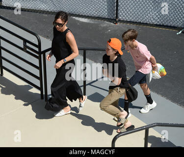 KEY BISCAYNE, FL - APRIL 01: David Beckham, Victoria Beckham, Harper Beckham,  Cruz Beckham, Romeo  Beckham and Brooklyn Beckham and friend Marcelo Claure CEO of Sprint  watch John Isner (USA) defeats Alexander Zverev (GER) 67(4) 64 64 in the Mens Final at the Miami Open held at the Crandon Park Tennis Center on April 1, 2018 in Key Biscayne, Florida   People:  Victoria Beckham, Romeo Beckham, Cruz Beckham Stock Photo