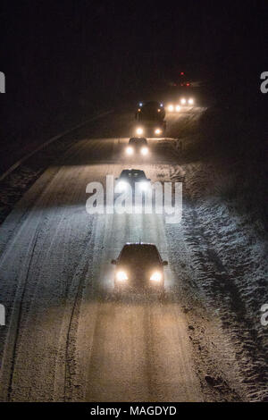 Flintshire, Wales, UK 2nd April 2018, UK Weather: A washout Easter Bank Holiday ends with a Met Officer weather warning for rain and snow for Bank Holiday Monday as Flintshire gets covered in snow. Motorists on the A55 passing through Flintshire down to single lane traffic as heavy snowfall causes hazardous driving conditions on Easter Bank Holiday Monday © DGDImages/Alamy Live News Stock Photo