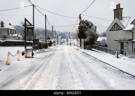 Flintshire, Wales, UK 2nd April 2018, UK Weather: A washout Easter Bank Holiday ends with a Met Officer weather warning for rain and snow for Bank Holiday Monday. A very snowy main village road through the village of Lixwm in rural Flinthsire on Easter Bank Holiday Monday © DGDImages/Alamy Live News Stock Photo