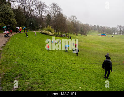 Avenham Park, Lancashire, UK, 2 April 2018. Traditional Easter Egg Rolling down the hill at Avenham Park, Preston on a very wet Easter Monday, Preston, Lancashire, UK Credit: Sue Burton/Alamy Live News Stock Photo