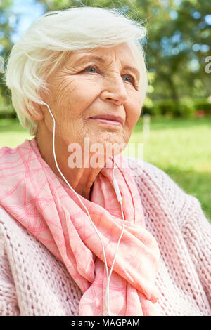 Senior Woman Listening to Music Stock Photo