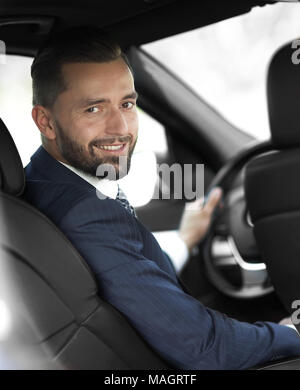 businessman sitting at the wheel of a car and looking at the camera Stock Photo