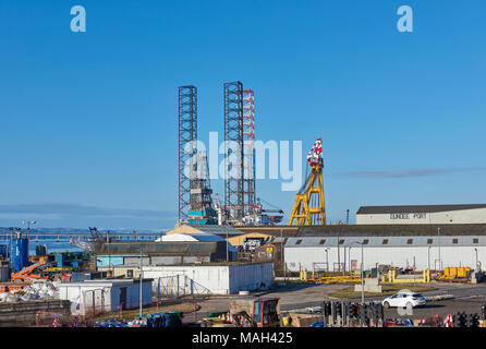 Away at the northern end of Dundee Port lie the Rowan Norway Drilling Rig and the Asian Hercules III Sheerleg Crane on a Bright Spring Day Stock Photo