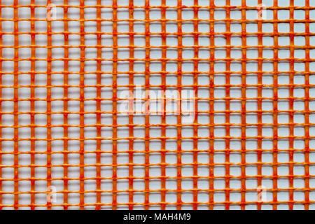 Orange plastic grid on white background surface Stock Photo