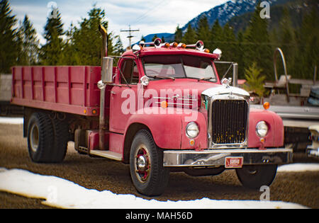 A red Mack B-75 stake body work truck, near Noxon, Montana. Mack's B Series trucks were produced from 1953 and 1966. Stock Photo