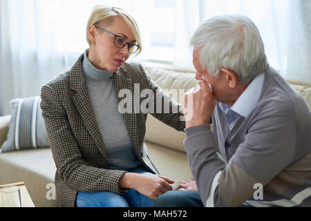 Senior Man Crying in Therapy Session Stock Photo