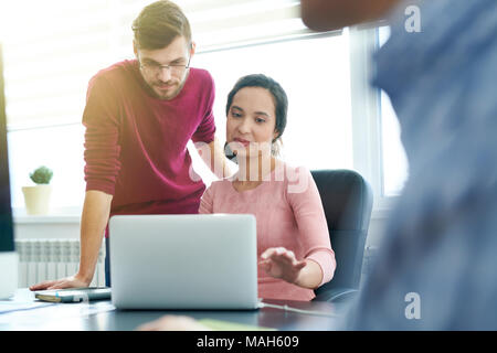 Business colleagues analyzing online report Stock Photo