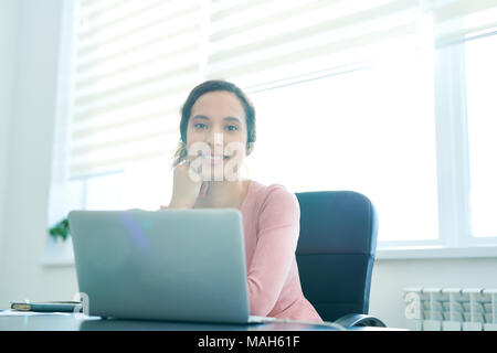 Happy Hispanic office manager Stock Photo