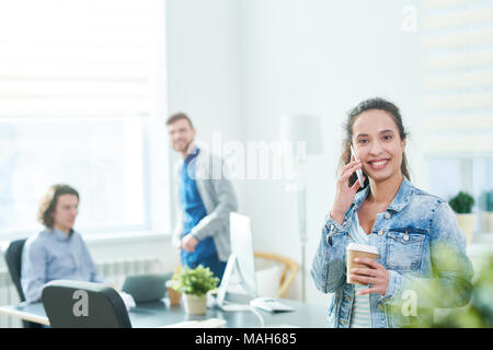 Excited modern office manager talking on phone friendly