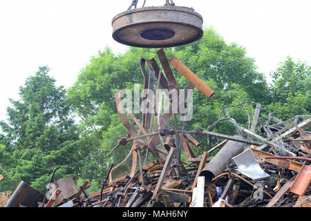 electromagnetic on crane sorting through scrap metal at scrapyard leeds yorkshire united kingdom Stock Photo
