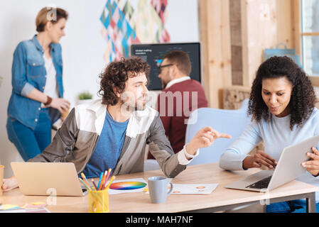 Happy colleagues working together on a project Stock Photo