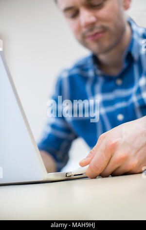 Man Backing Up Computer Data Onto Memory Stick Stock Photo
