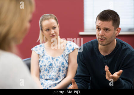 Couple Discussing Problems With Relationship Counselor Stock Photo