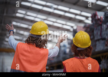 Engineer woman in industry factory checking production Stock Photo
