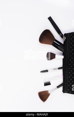 Makeup Brushes in comestic bag  isolated on white background. Stock Photo