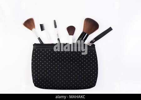 Makeup Brushes in comestic bag  isolated on white background. Stock Photo