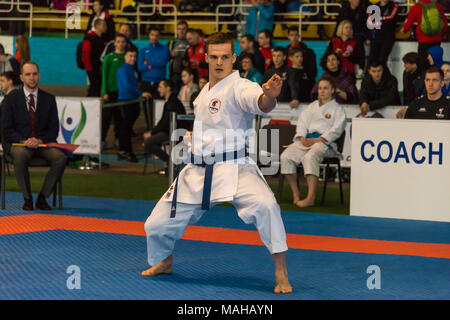 Lviv , Ukraine - March 25, 2018: International open karate cup . Unknown athlete performs during the competition  in the sports complex of the army,   Stock Photo