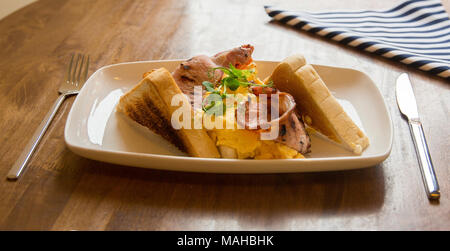Scrambled eggs and bacon with toast Stock Photo