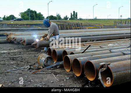 Workers are welding steel on road construction site Stock Photo