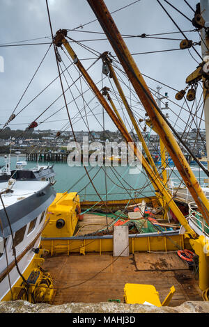 fishing boats and trawlers alongside moored in the cornish fishermans docks at newlyn in cornwall. trawling gear and deep sea trawlers in port newlyn. Stock Photo