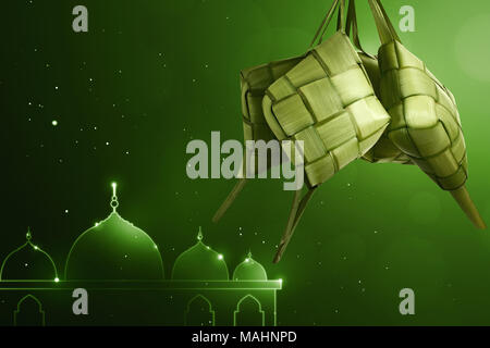 Rice dumpling (ketupat) for eid celebration with green background Stock Photo