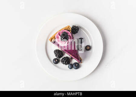 top view of blueberry cake with fresh berries on plate isolated on white Stock Photo