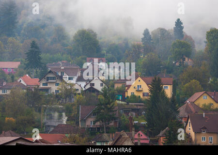 The mist rises on an early autumn Sunday in the historic town of Sighișoara, Romania. Stock Photo