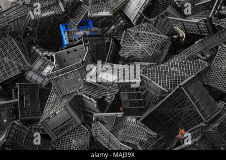 Piled black crates for scrap Stock Photo