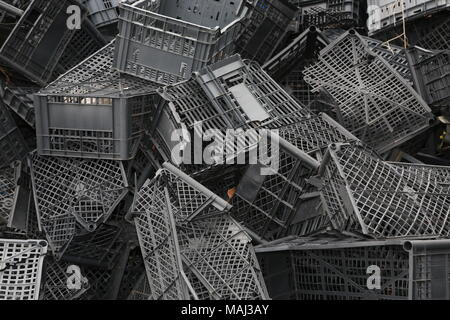Piled black crates for scrap Stock Photo