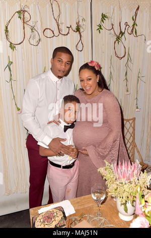 Cory Hardrict, his son Cree Taylor Hardrict and his wife Tia Mowry attend the Tia Mowry's Babyparty at Il Pastaio restaurant on March 31, 2018 in Beverly Hills, California. Stock Photo