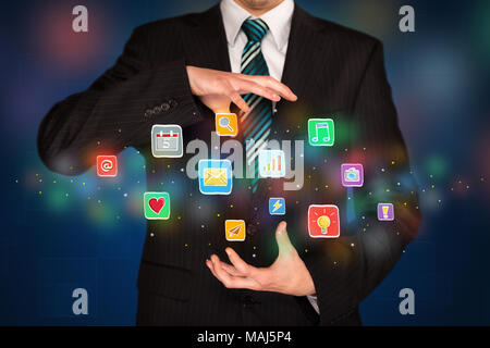 Elegant businessman holding colorful mixed media icons  Stock Photo