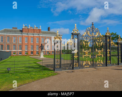 View of Kensington Palace, a royal residence situated in Kensington Gardens with a statue of King William III in London on a sunny day.
