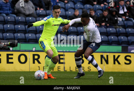 Derby County's Tom Lawrence and Preston North End's Darnell Fisher battle for the ball during the Championship match at Deepdale, Preston. Stock Photo