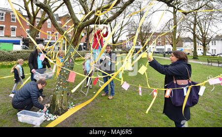 Ribbons, jokes, hand-made flowers and painted stones are added to a tree in Fortune Green in West Hampstead, London, on the 2nd anniversary Nazanin Zaghari-Ratcliffe's detention in Iran. Stock Photo